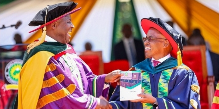 A photo of Meru University of Science and Technology (MUST) Chancellor Dr. Peter Ndegwa shares a light moment with founding Chancellor Dr. James Mwangi during the 12th graduation ceremony in October 2024. PHOTO/ Meru University 