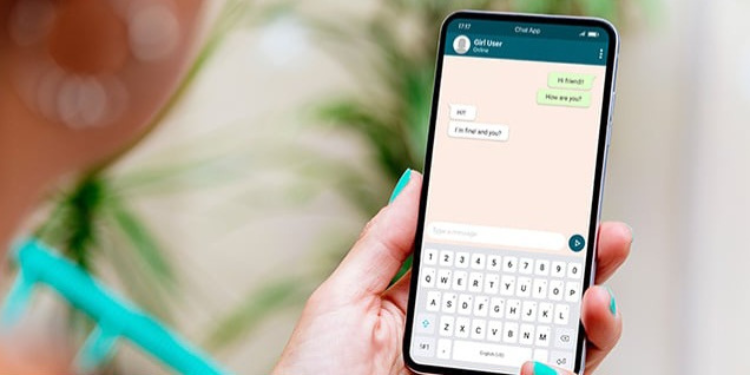 A person holding a phone on WhatsApp PHOTO/iStock