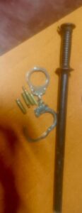 A pair of handcuff and police baton. PHOTO/ National Police X Account 