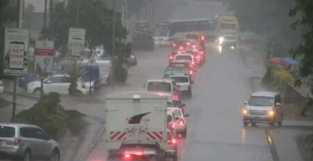 Motorists using a flooded highway during cold and rainy weather in Nairobi