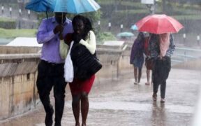 Nairobi residents use umbrellas during a past rainfall in Nairobi, Kenya. PHOTO/Nation.