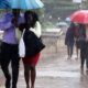 Nairobi residents use umbrellas during a past rainfall in Nairobi, Kenya. PHOTO/Nation.