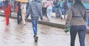Nairobi residents walking on rainy season. PHOTO/ The Star