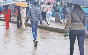 Nairobi residents walking on rainy season. PHOTO/ The Star