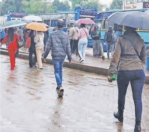 Nairobi residents walking on rainy season. PHOTO/ The Star
