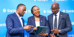 Sanlam Life's Head of Innovations, Isaac Mwangi (left), with Sanlam Life CEO Jacqueline Karasha (centre) and the firm’s Head of Retirement Benefits, Jack Marwa, share a light moment at the Sanlam Akiba Plus pension solution launch