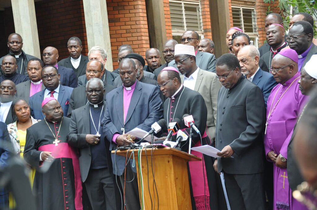 Catholic Archbishop Martin Kivuva Musonde of Mombasa, at podium, is joined by a variety of Kenyan religious leaders during a news conference in Nairobi, Dec. 3, 2024. PHOTO/Fredrick Nzwili. pOLITICS