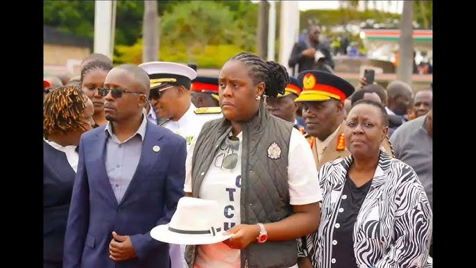 Winnie Odinga with his father hat at JKIA. PHOTO/UGC.