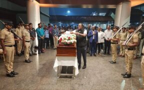 Winnie Placing the icon hat on the casket Image/X