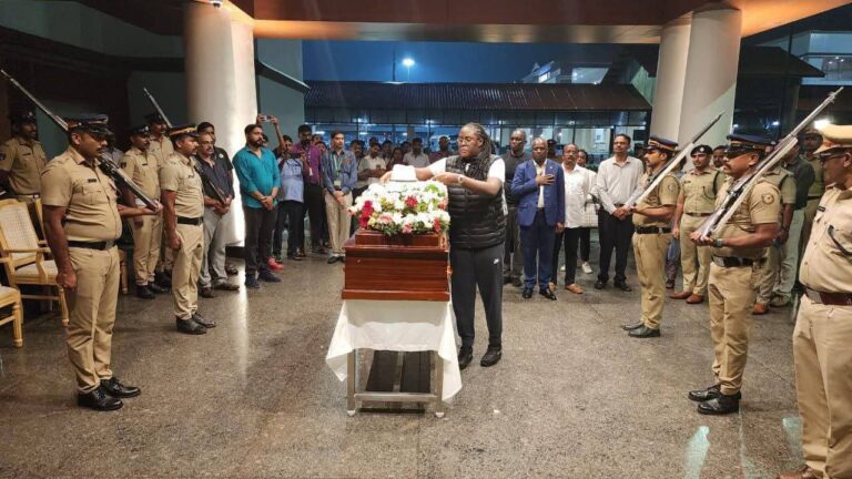 Winnie Placing the icon hat on the casket Image/X