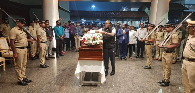 Winnie Placing the icon hat on the casket Image/X
