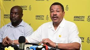 Amnesty International official speaking to press at past event. PHOTO/AM