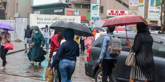 Nairobi residents walking in the rain. PHOTO/FILE