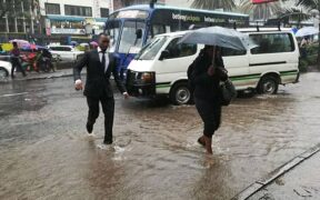 Section of Nairobi residents walking in rain. PHOTO/S