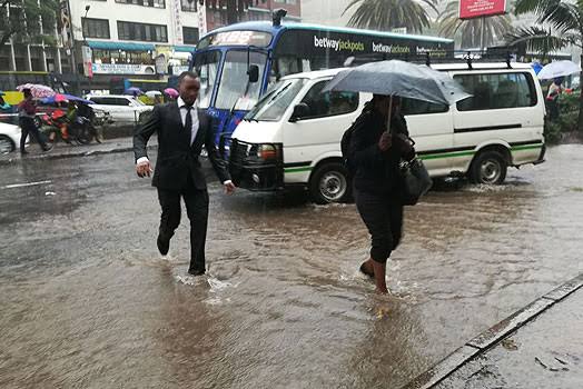 Section of Nairobi residents walking in rain. PHOTO/S