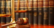 The Image Depicts a Legal Eetting, Featuring a Wooden Gavel and a Scale of Justice in the Foreground, with a Row of Law Books in the Background. PHOTO/ Courtesy