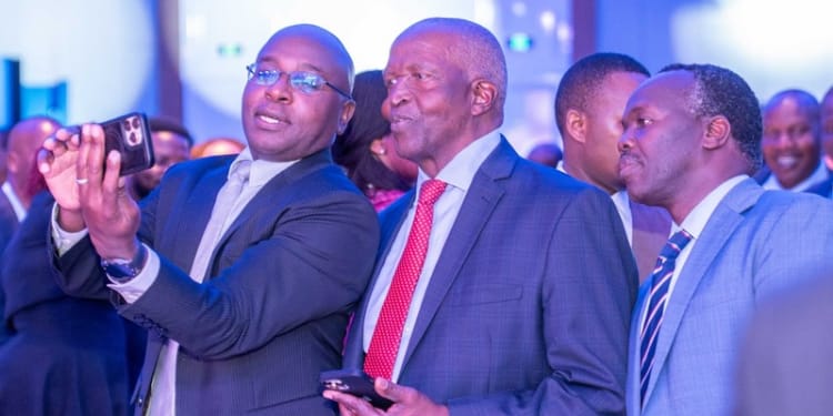 Kenya Revenue Authority (KRA) Commissioner General Humphrey Wattanga (left) takes a selfie with SanlamAllianz Kenya Chairman Dr John Simba (centre) and Insurance Regulatory Authority CEO Godfrey Kiptum (right) at the SanlamAllianz Kenya rebrand ceremony.