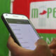 The Image Shows a Person Using the M-Pesa Mobile Money Transfer Service on a Smartphone. PHOTO/ COURTESY