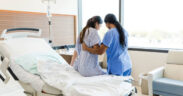An Unrecognizable Female Nurse Helps the Unrecognizable Woman Get out of the Hospital Bed. PHOTO/ Courtesy