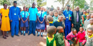 A picture showing police constable Moses Mangeni talking to young adults on schools Image/NPS/X