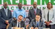 Amsons Group Managing Director, Mr Edha Nahdi (foreground left) and Sinoma CBMI Chairman, Mr Zhang Sicai (fore right), signing the US$250 million Matuga Clinker Factory Construction contract, witnessed by President William Ruto, Bamburi Cement Plc Chairman John Simba, MITI CS Lee Kinyanjui and Bamburi Cement Head of Legal and Company Secretary Joyce Munene.
