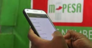 Photo of a Safaricom customer engaging in several transactions. PHOTO/NMG...M-Pesa