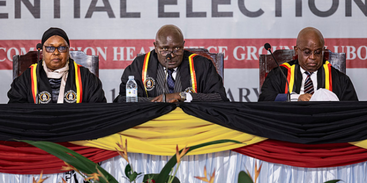 The Ugandan Electoral Commission Chairman, Justice Byabakama Mugenyi Simon (C) among with other Electoral Commission