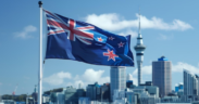 New Zealand Flag With A Background of The City's Buildings. PHOTO/ File