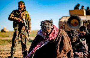 Men and boys suspected of being Islamic State fighters wait to be searched by members of the Kurdish-led Syrian Democratic Forces. Photograph: Delil Souleiman/AFP/Getty Images