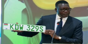 Transport Cabinet Secretary Davis Chirchir Holding The Electric Vehicles Green Number Plate. PHOTO/ File