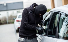 Balaclaved Individual Attempting A Forced Entry To A Parked Vehicle in Unnamed Location. PHOTO/ File