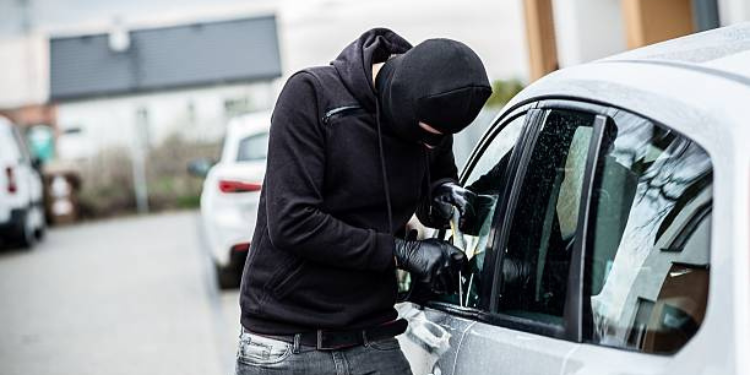 Balaclaved Individual Attempting A Forced Entry To A Parked Vehicle in Unnamed Location. PHOTO/ File