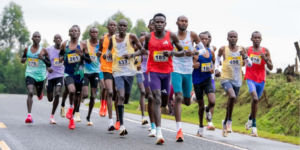 Amos Kiprotich(in red centre) leads the Men's pack during the Betika Kapsabet 15KM Road Race. PHOTO/ Dennis Murimi