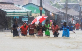 The image shows people moving in floods as most parts of the country keep receiving heavy rains PHOTO/File