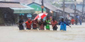 The image shows people moving in floods as most parts of the country keep receiving heavy rains PHOTO/File