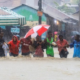 The image shows people moving in floods as most parts of the country keep receiving heavy rains PHOTO/File