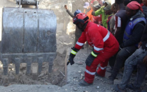 With Guidance from Kenya Red Cross Personnel a bulldozer is guided to dig out rubbles of the Shauri Moyo Building as Rescue Operations Continue. PHOTO/ KRC