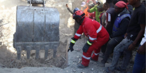 With Guidance from Kenya Red Cross Personnel a bulldozer is guided to dig out rubbles of the Shauri Moyo Building as Rescue Operations Continue. PHOTO/ KRC