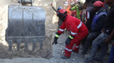 With Guidance from Kenya Red Cross Personnel a bulldozer is guided to dig out rubbles of the Shauri Moyo Building as Rescue Operations Continue. PHOTO/ KRC