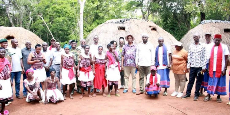 Runyenjes MP Muchangi Karemba posing for a photo with the members of Kaya Kauma community in Kilifi County. PHOTO/ PCS