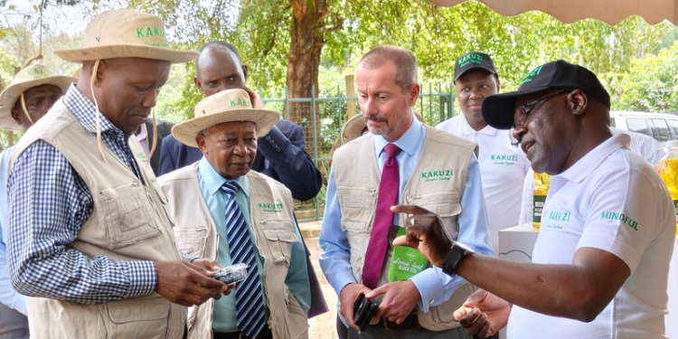 Kakuzi Blueberry Manager Laban Koima (right) explains package features to Investments, Trade and Industry Cabinet Secretary Lee Kinyanjui (second left) during his recent visit to Kakuzi Plc orchards in Murang'a County, as the firm's Chairman Nicholas Ng'ang'a and Managing Director Chris Flowers (right) look on