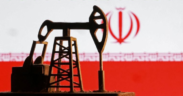Model of an oil pump in front of the Iranian flag PHOTO/Reuters
