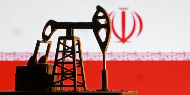 Model of an oil pump in front of the Iranian flag PHOTO/Reuters