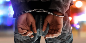 A photo of a man in police handcuffs. PHOTO/ istock images