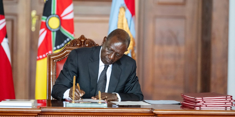 President Ruto signing the bill into law