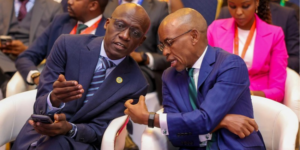 Safaricom’s CEO Peter Ndegwa speaking to a colleague during the Connected Africa Summit held in Nairobi. PHOTO/ File 