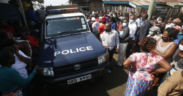A police land cruiser surrounded by locals at a past crime scene Photo NPS