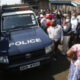 A police land cruiser surrounded by locals at a past crime scene Photo NPS