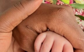 Apicture of Betty Kyalo and Charlie holding their baby's hand