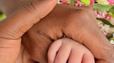 Apicture of Betty Kyalo and Charlie holding their baby's hand